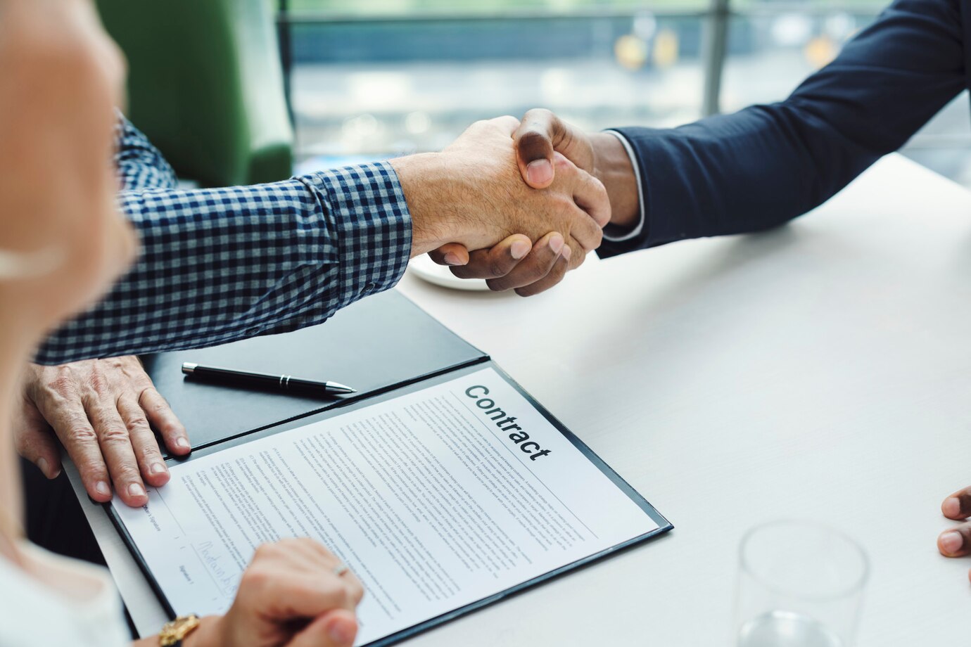 A handshake between two commercial lawyers in Perth, signifying the completion of a contract negotiation.