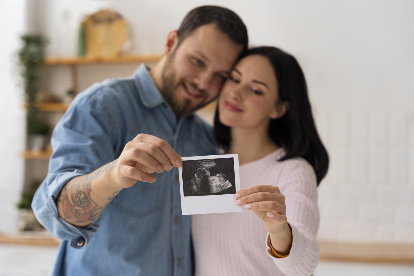 A couple proudly displays a photo of their baby, symbolizing their journey with surrogacy in Perth.